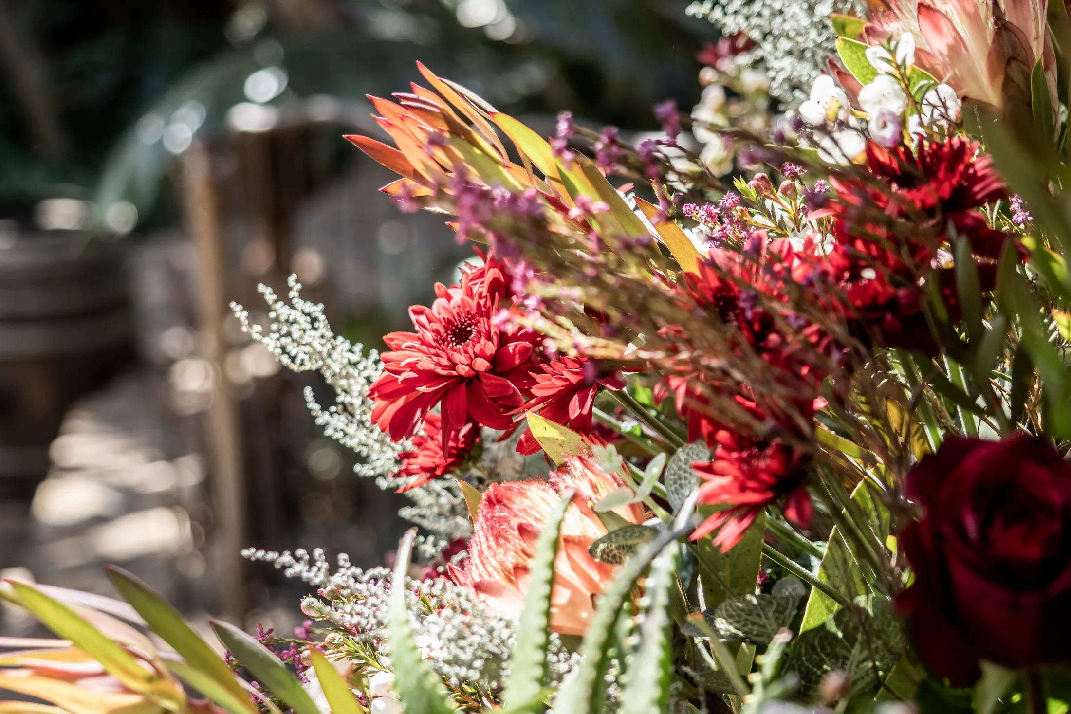 Burgundy wedding flowers and table details