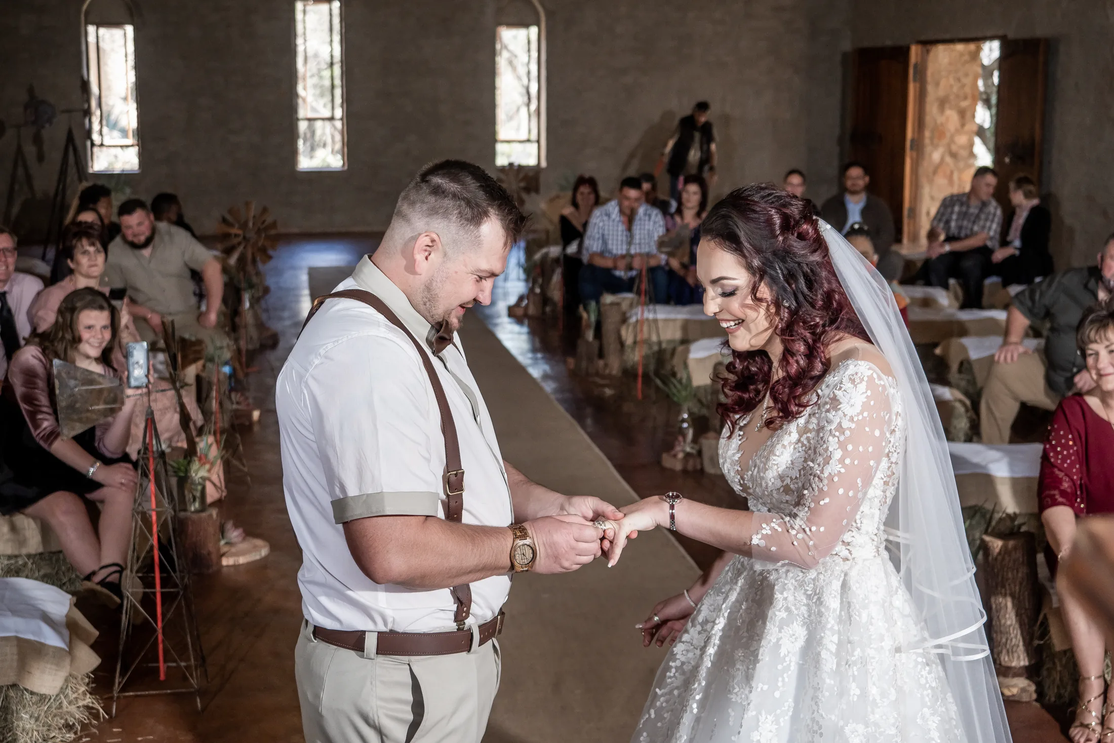Armand and Melanie exchanging vows in the stone chapel