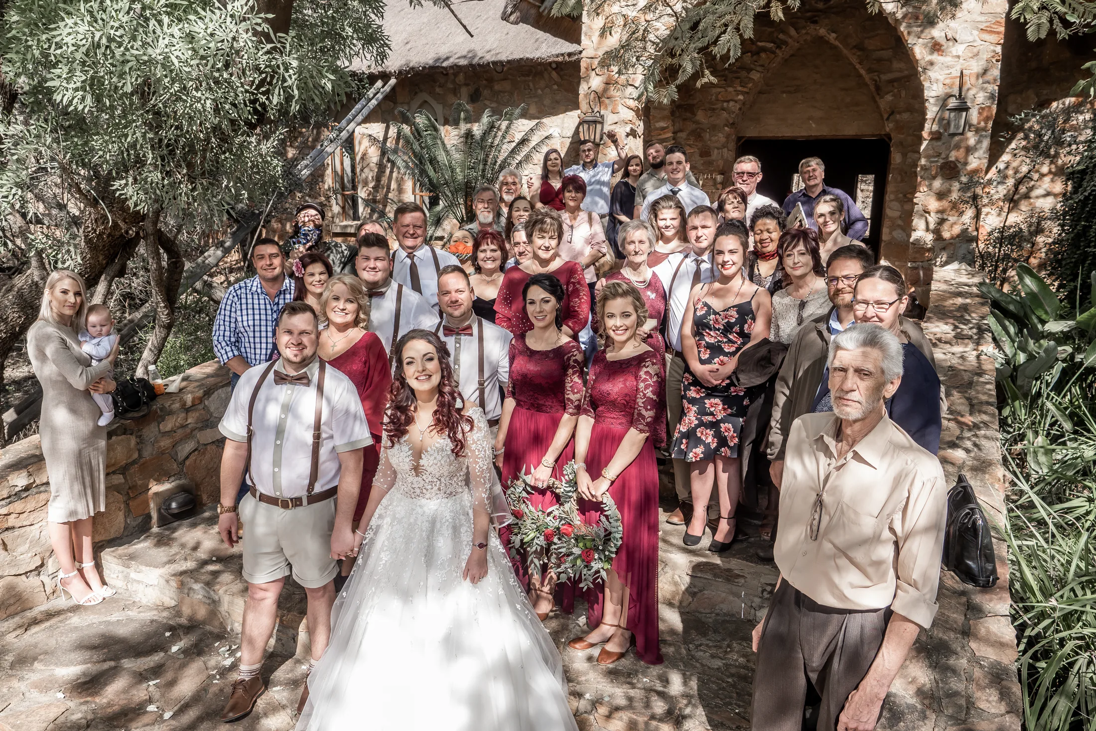 Wedding guests celebrating outside the stone chapel