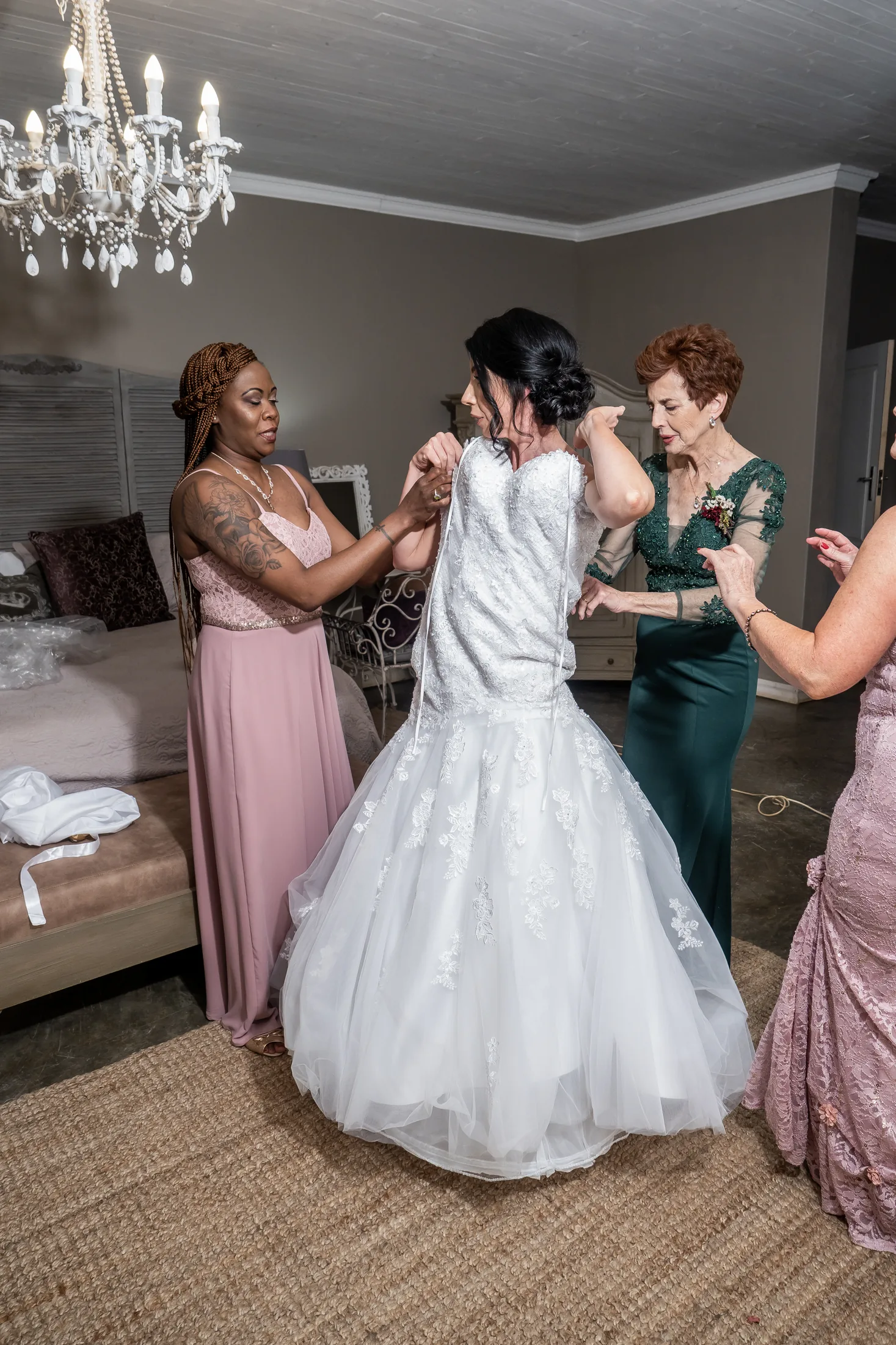 Bridesmaids helping Karen into her wedding dress
