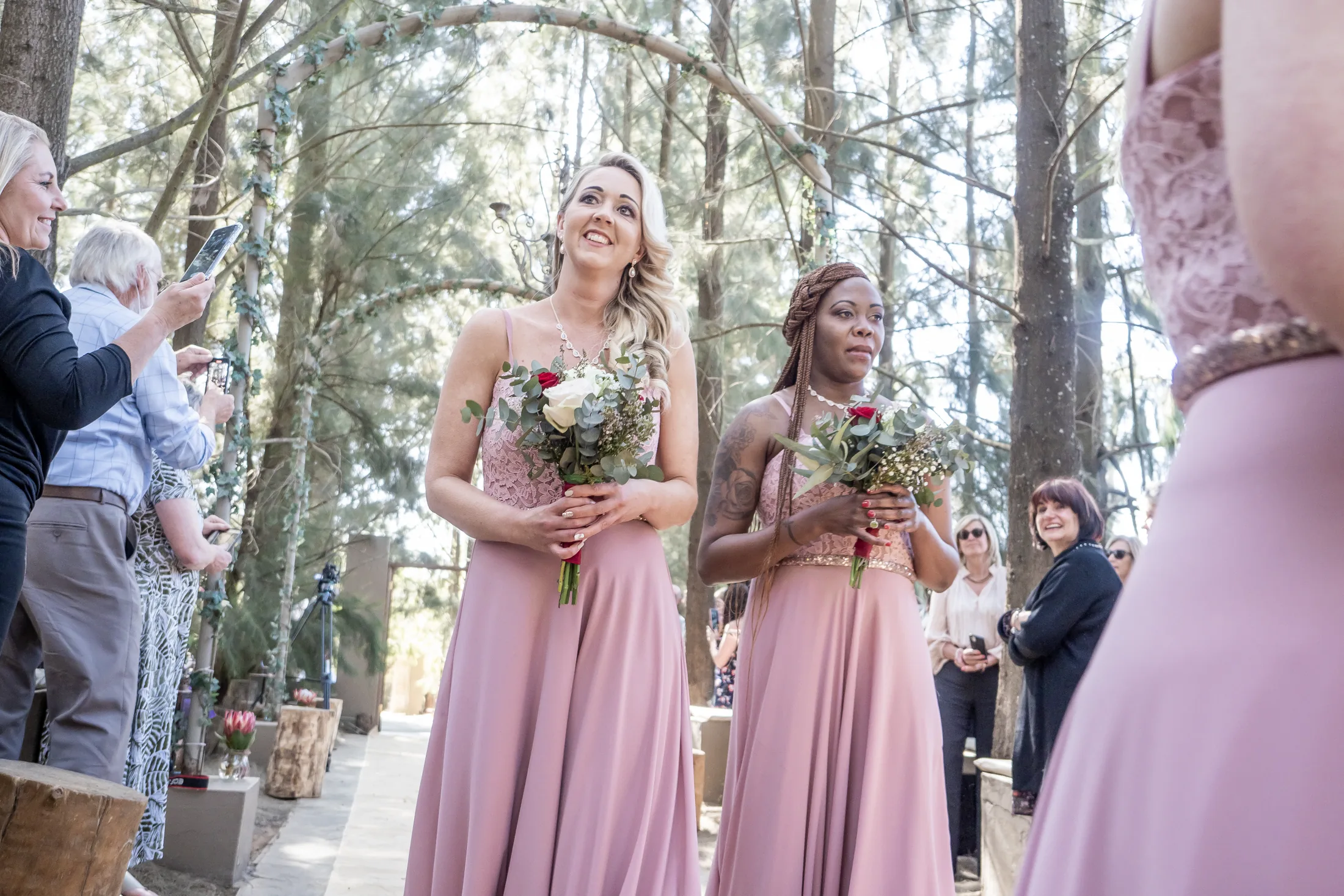 Bridesmaids entering the pine forest chapel