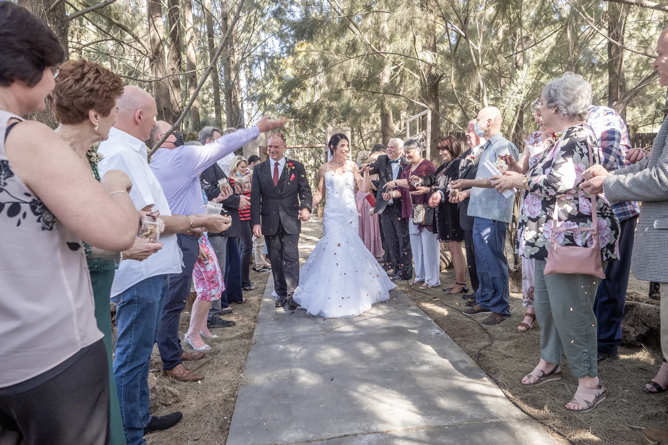 Billy and Karen walking through confetti after the ceremony