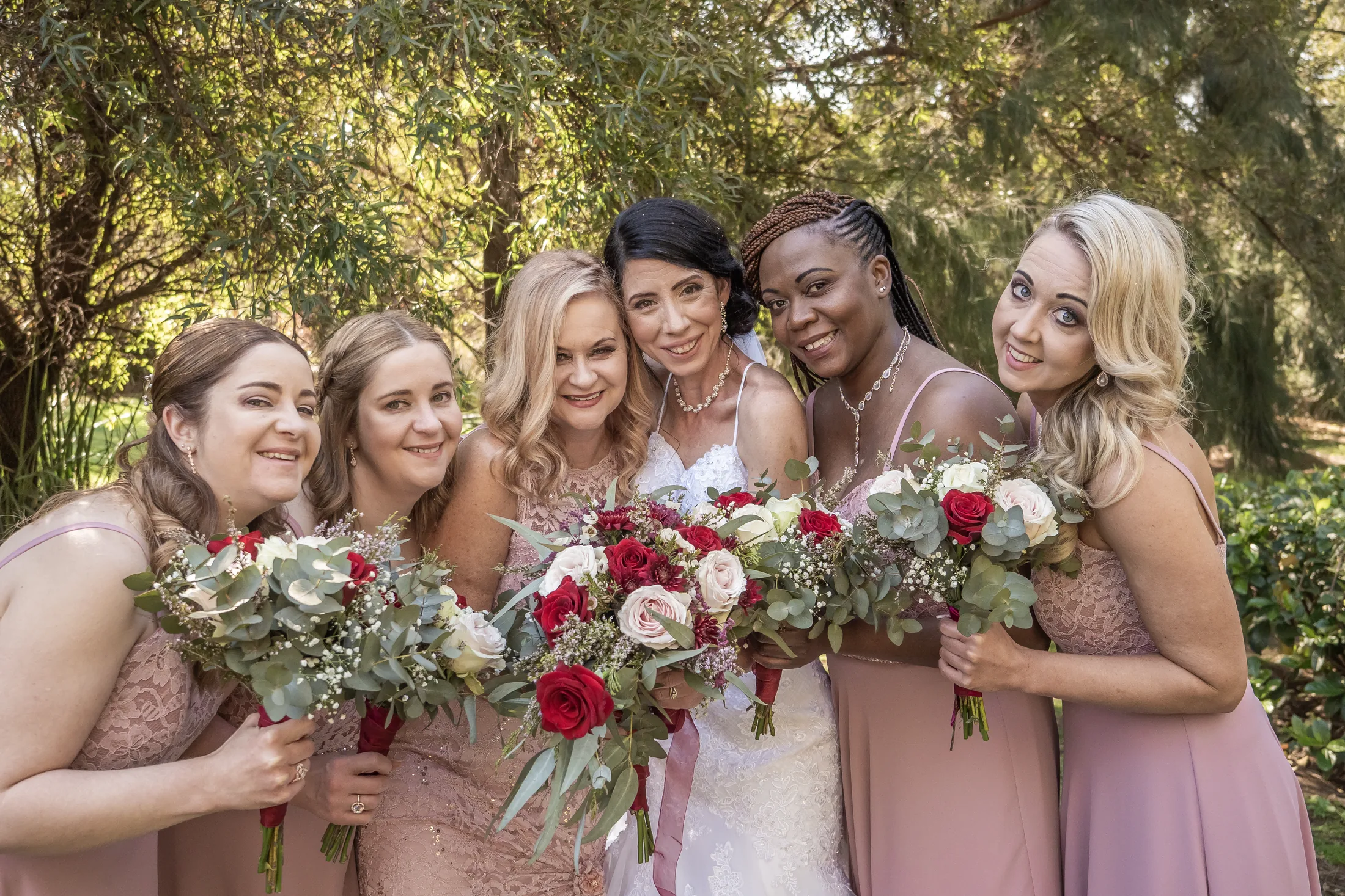 Karen with her bridesmaids in blush dresses