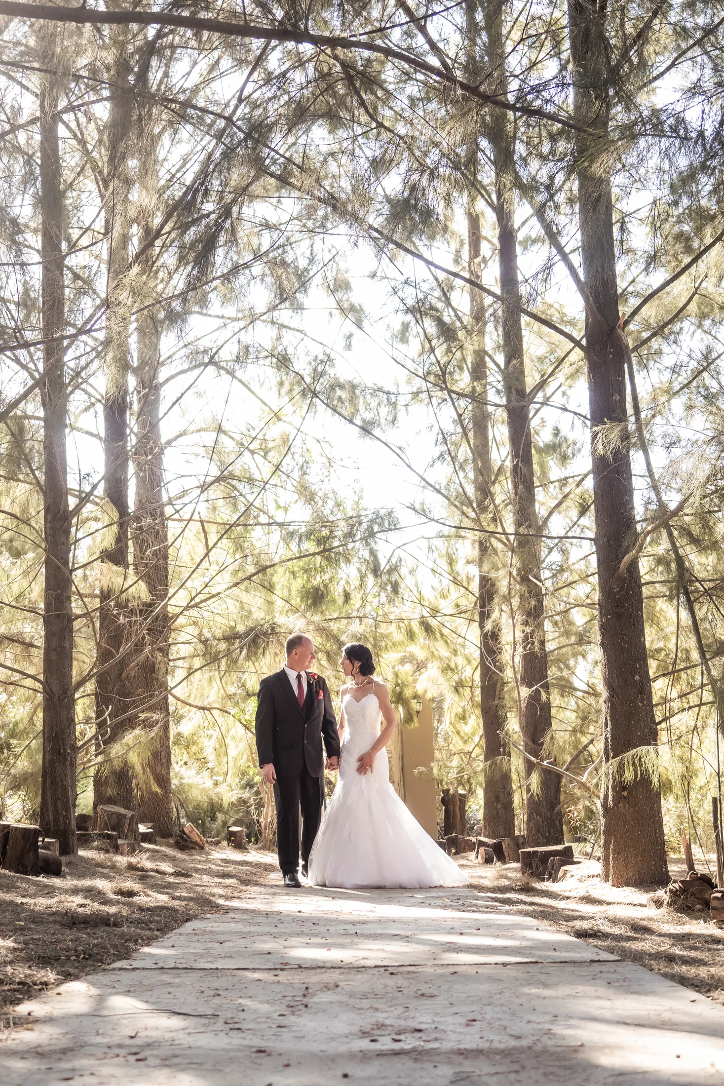 Billy and Karen together on a sunlit forest path