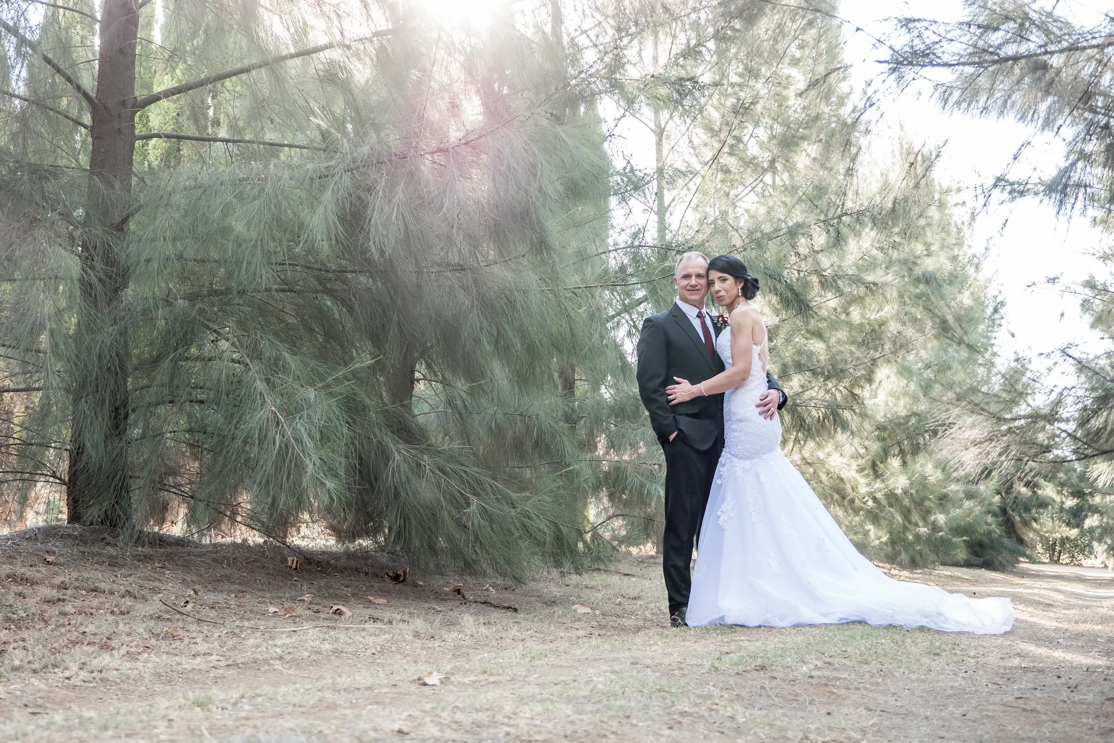 Billy and Karen embracing among the trees