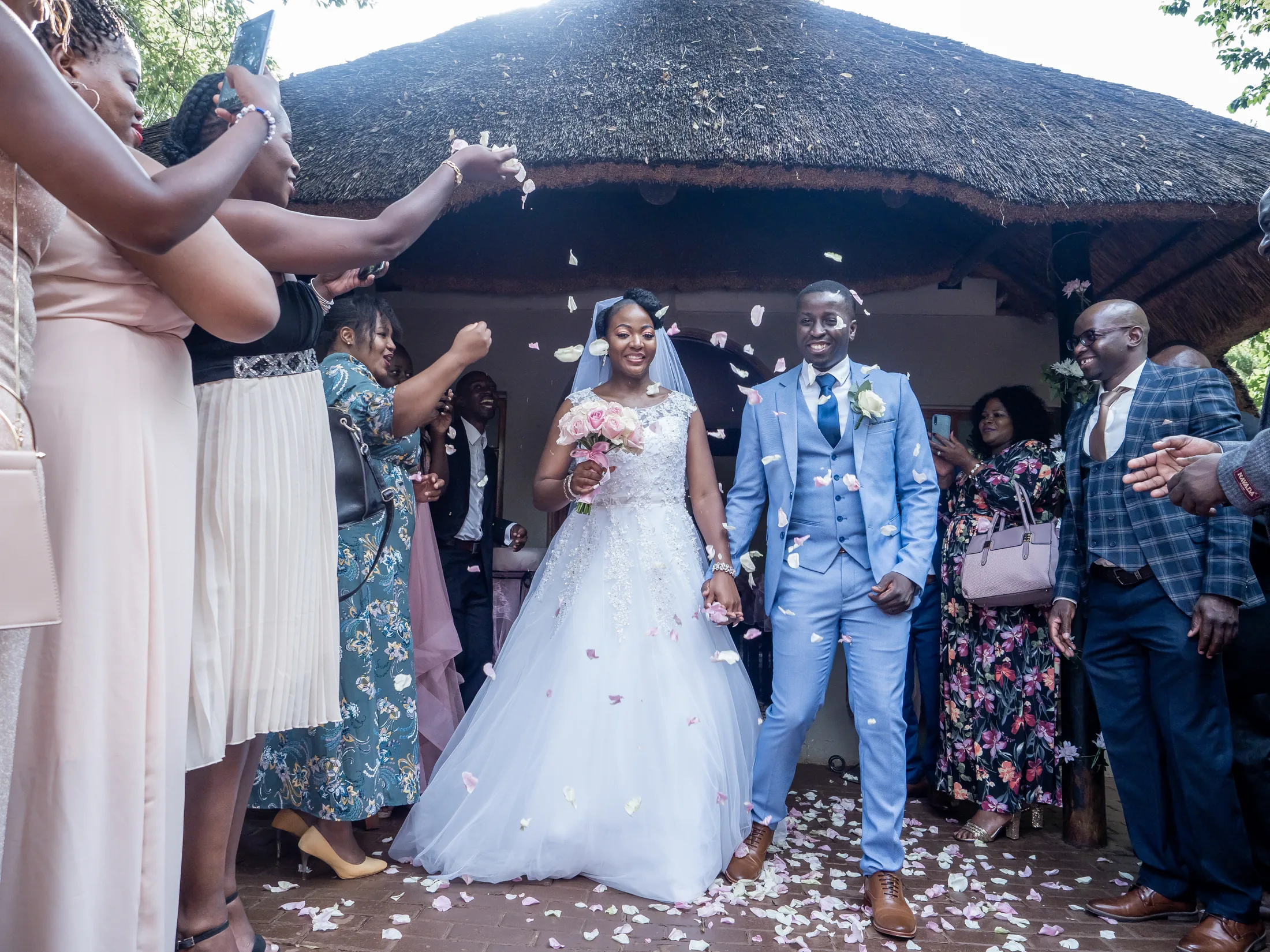 Dumi and Karabo leaving the ceremony beneath confetti