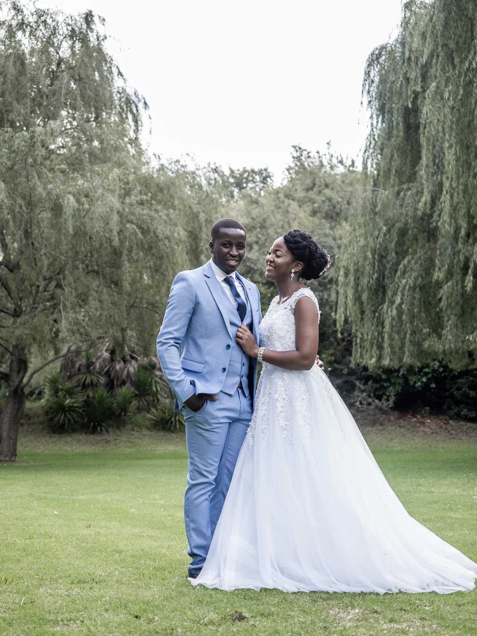 Full-length portrait of Dumi and Karabo beneath the trees