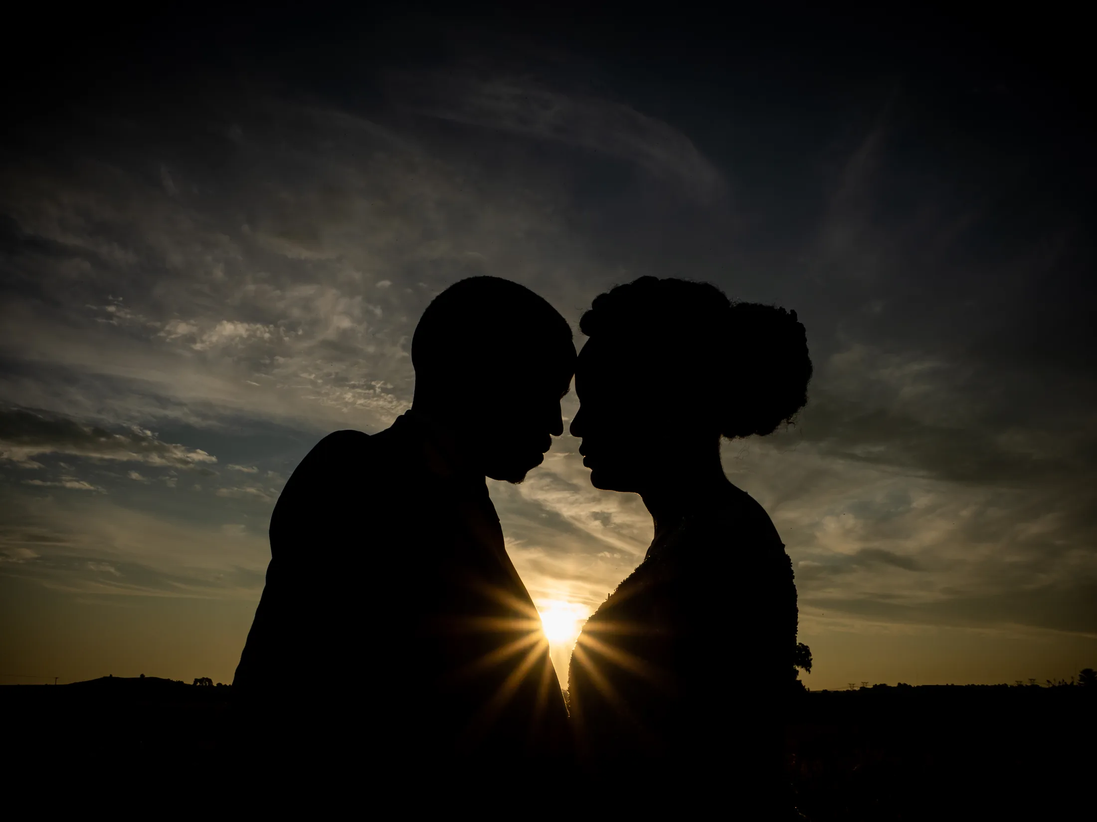 Silhouette of Dumi and Karabo against the sunset