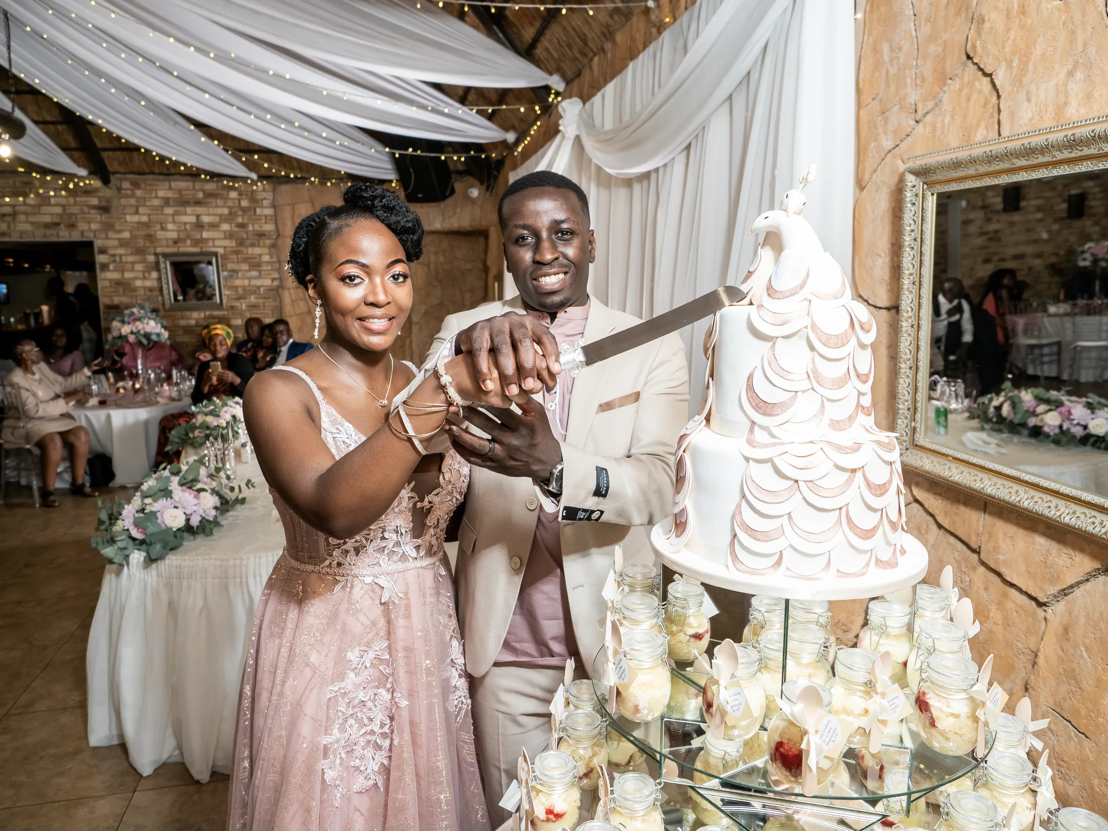 Dumi and Karabo cutting their wedding cake