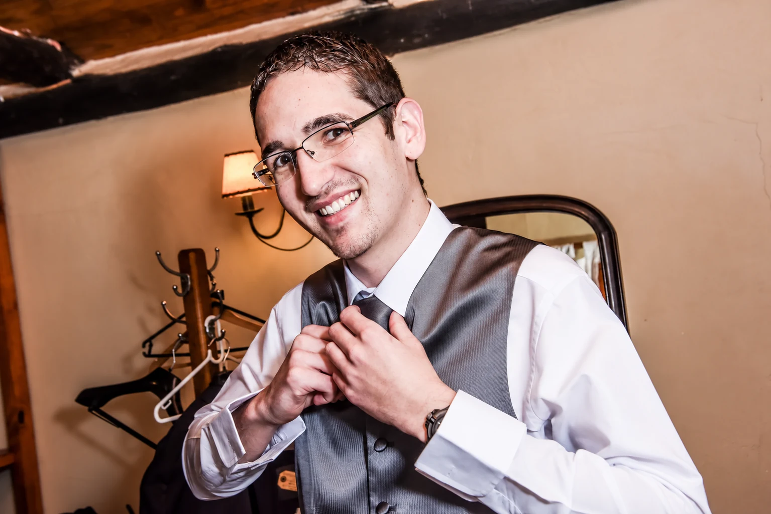 Ettienne adjusting his tie before the wedding