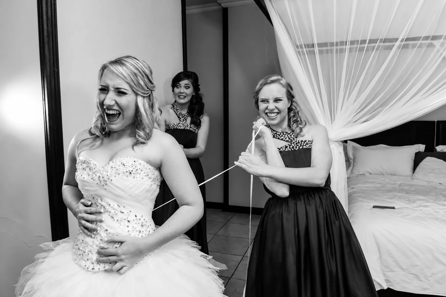 Dorme being helped into her wedding dress