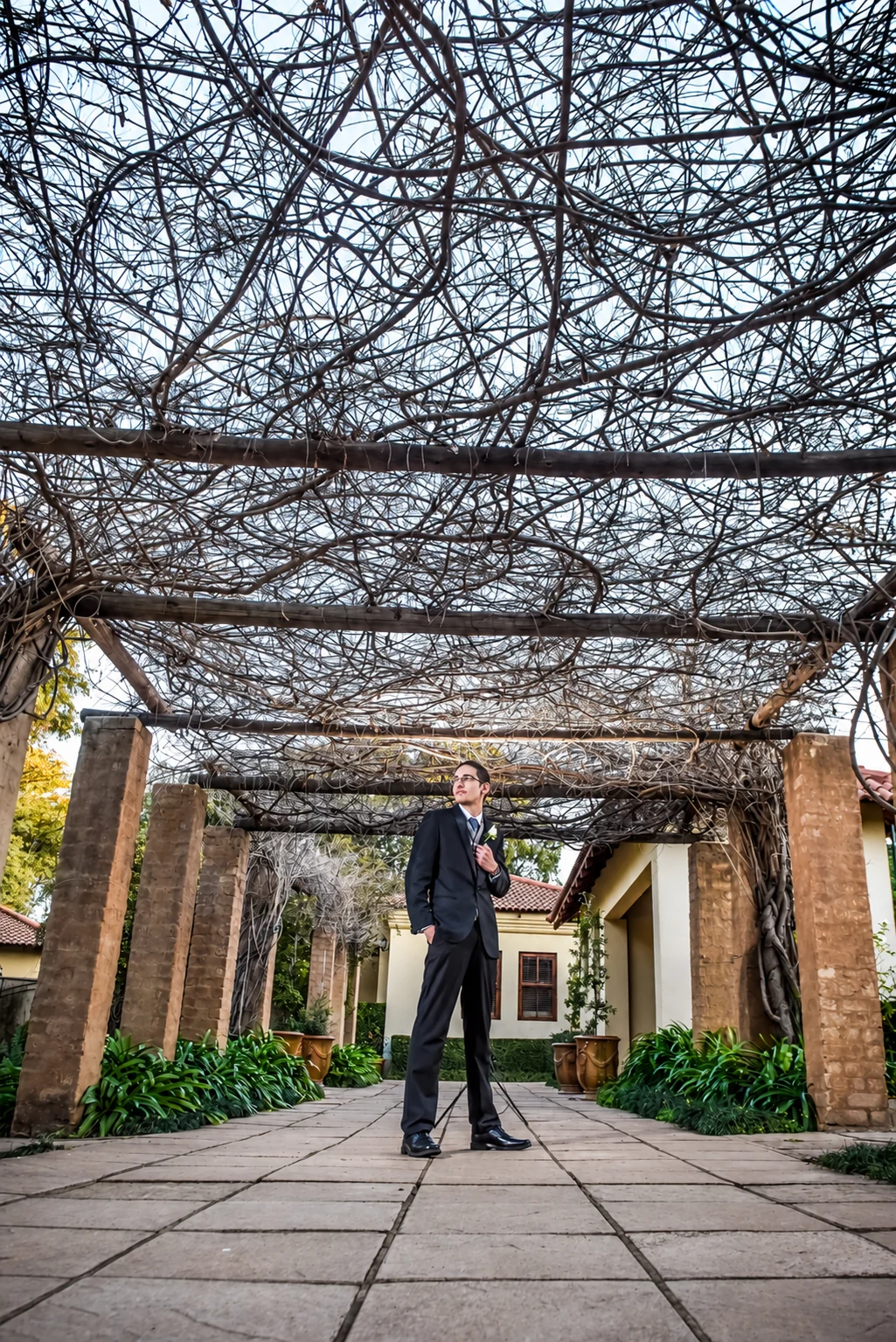 Ettienne standing beneath the garden pergola