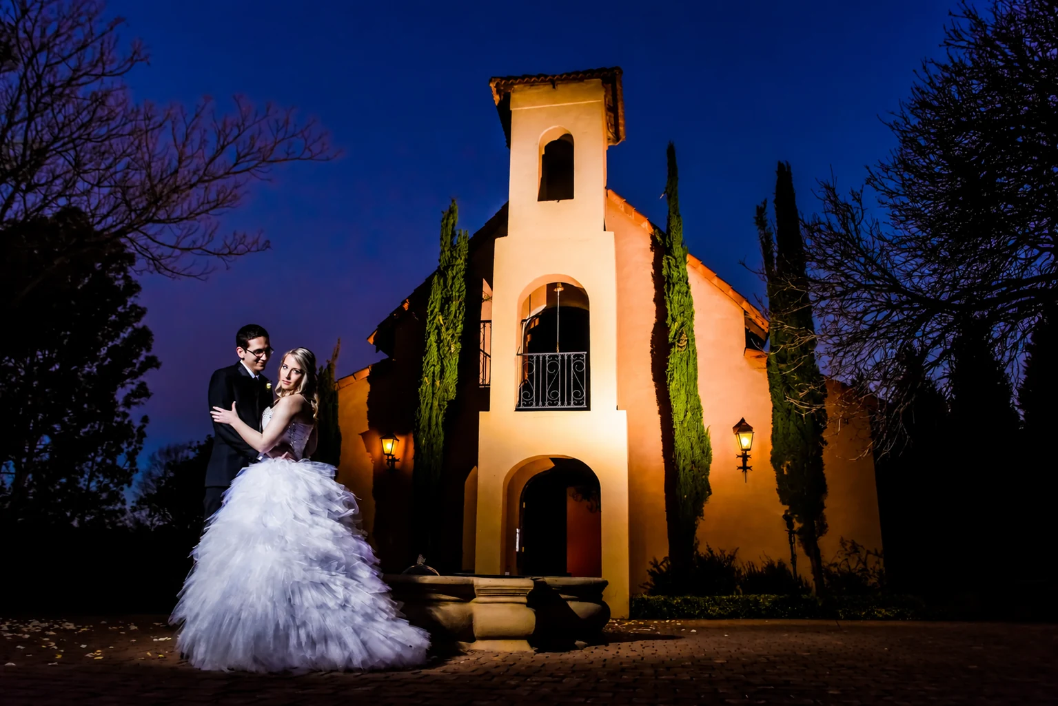 Ettienne and Dorme at dusk in front of the illuminated Moon and Sixpence venue