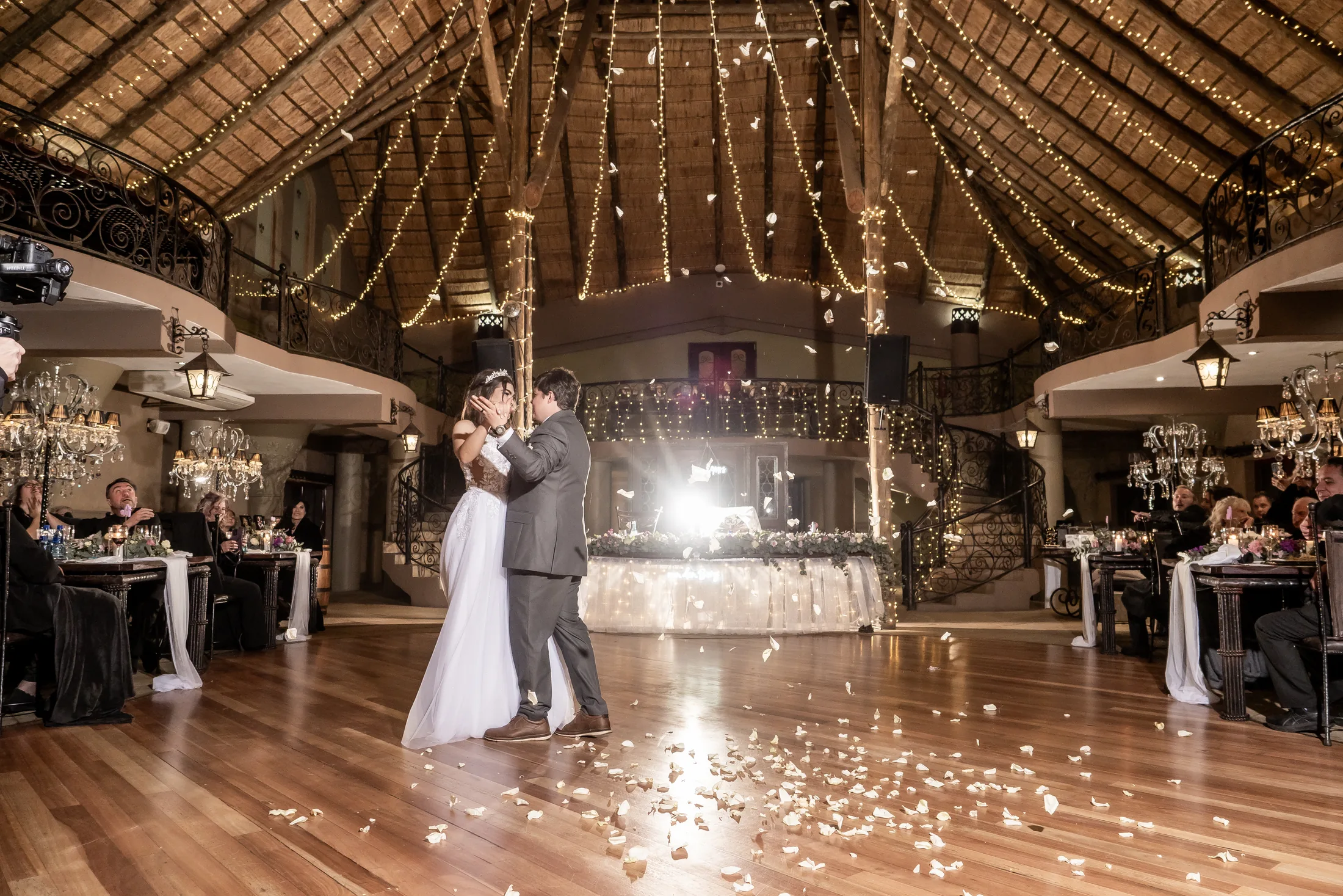 Franco and Anastasia dancing beneath the reception lights