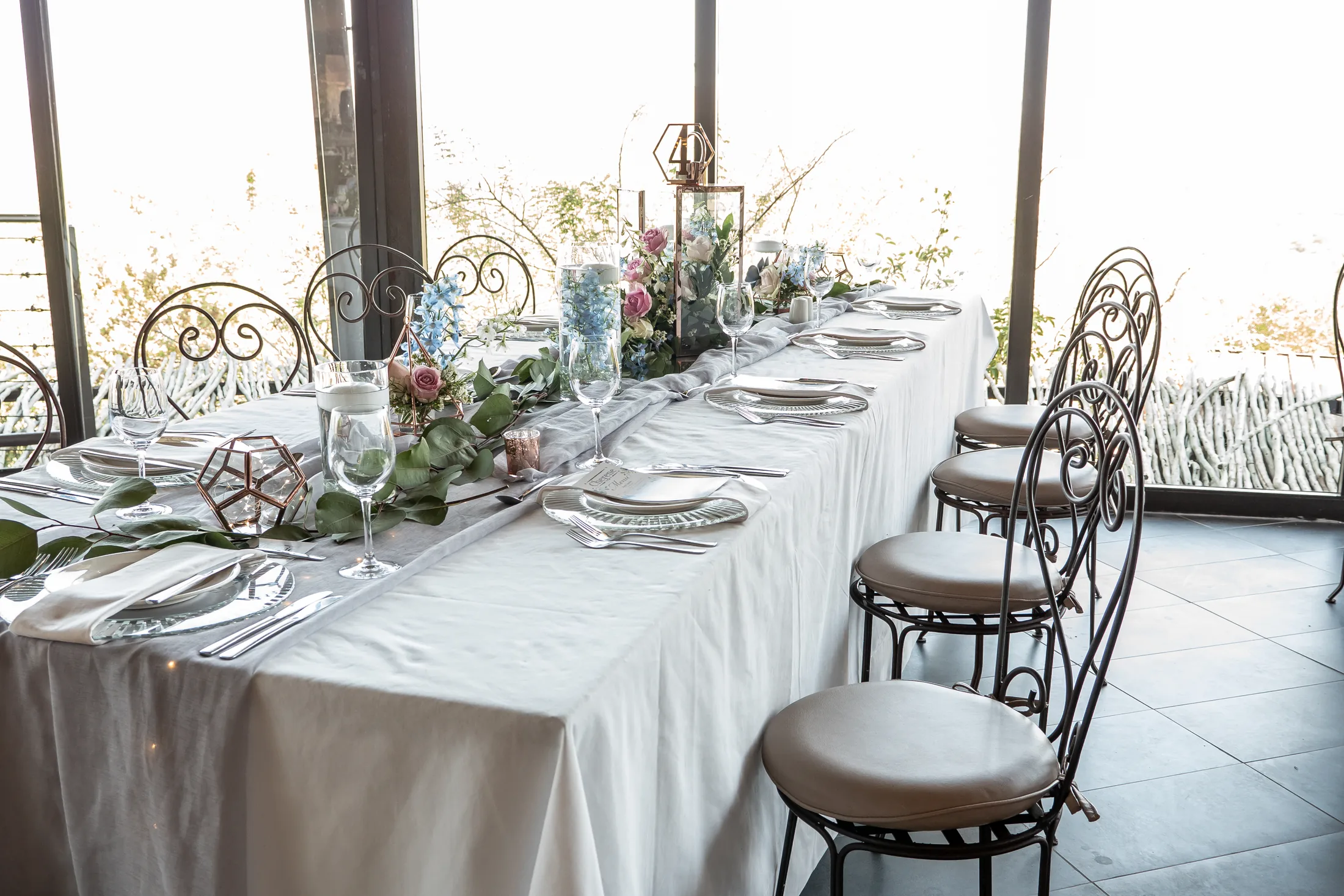 Reception table dressed with greenery and floral details