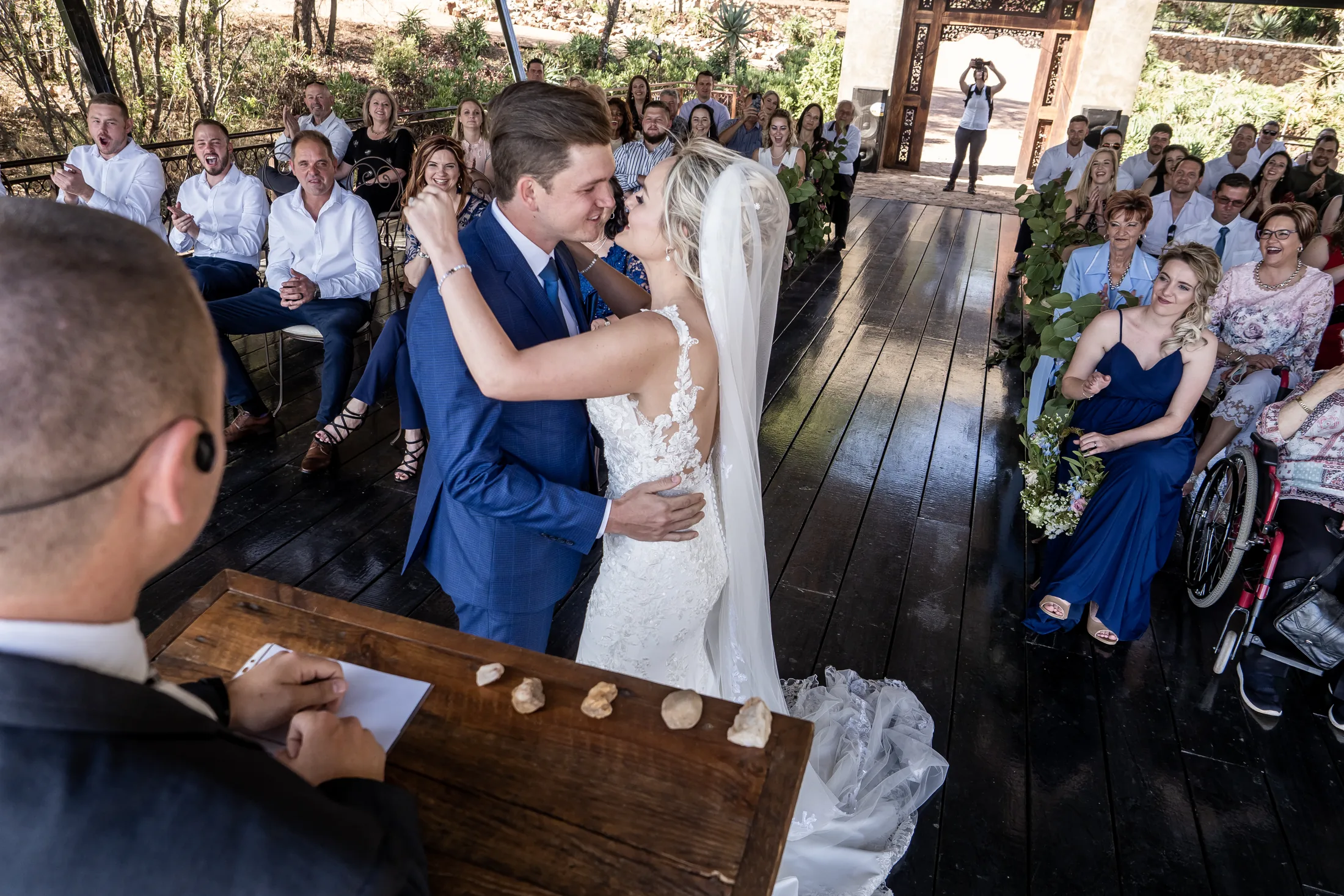 Xander and Leani sharing a kiss at the ceremony