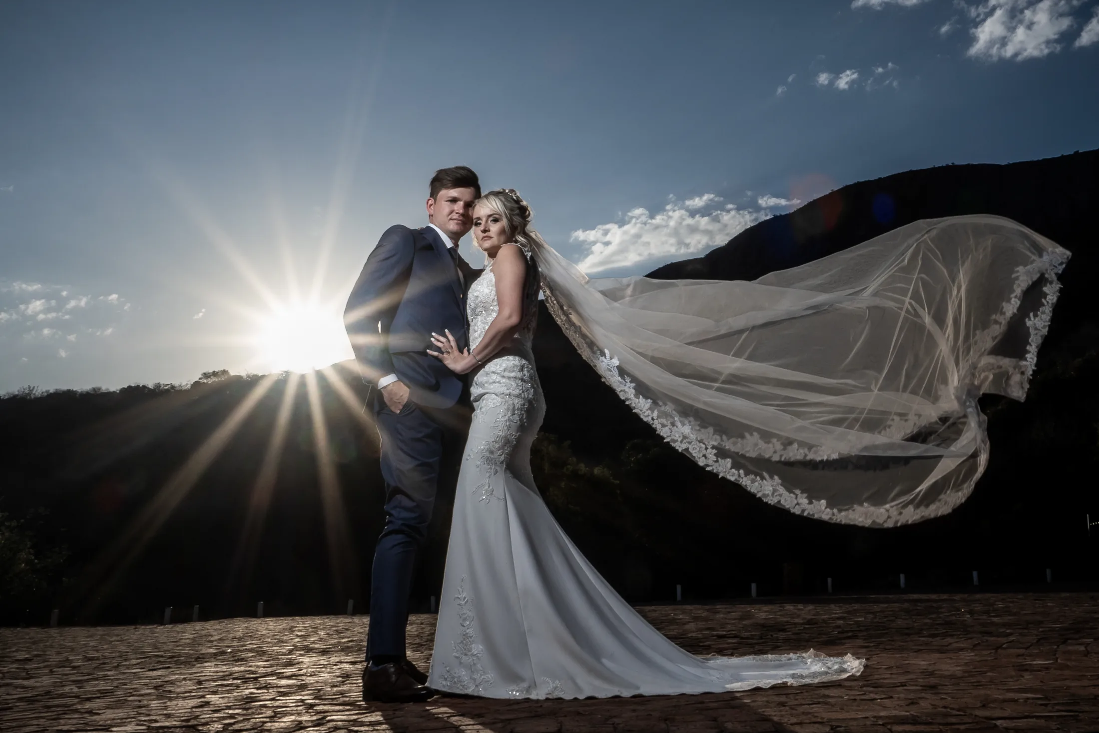 Xander and Leani at sunset with a flowing veil at Red Ivory Lodge