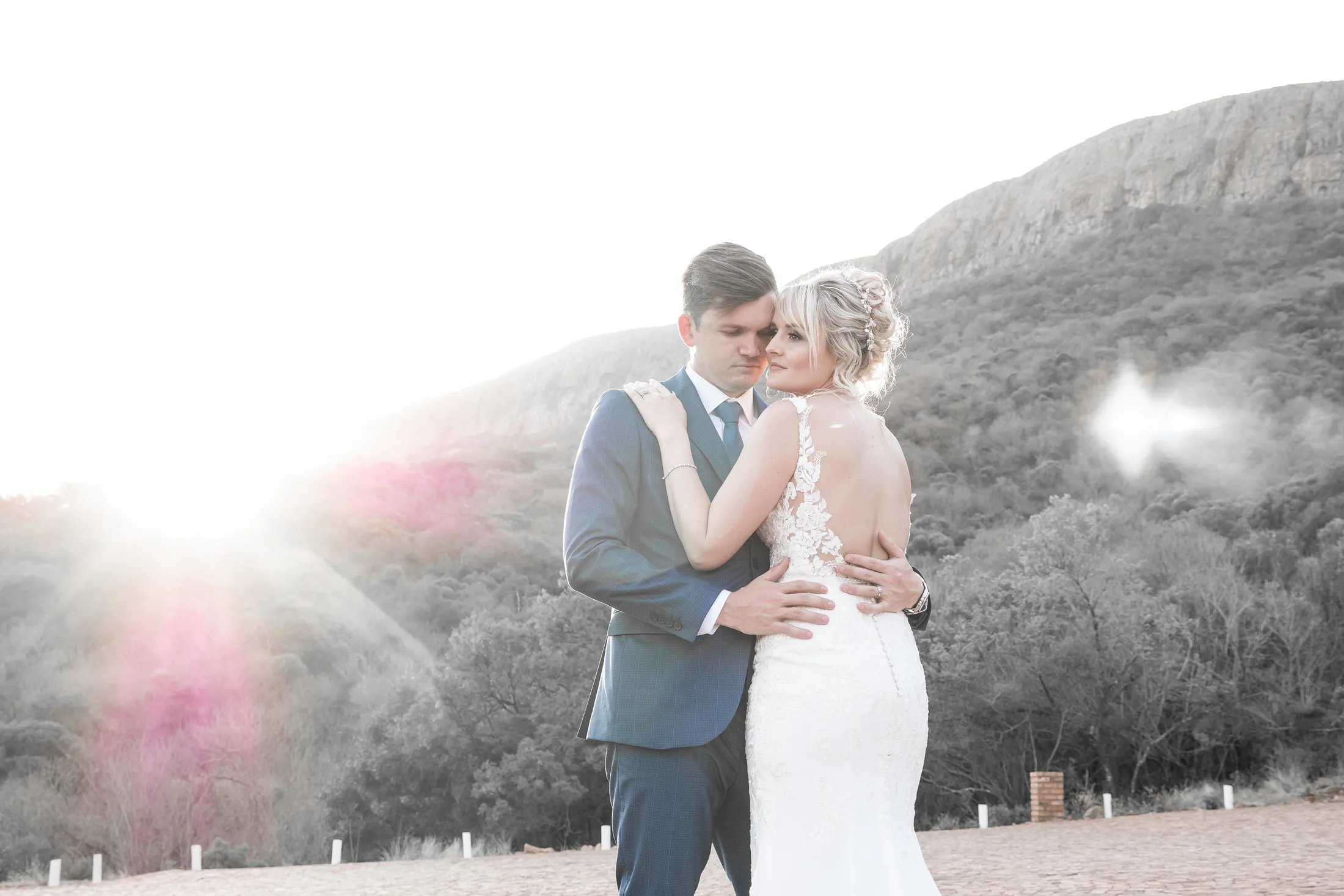 Xander and Leani embracing in the last sunlight